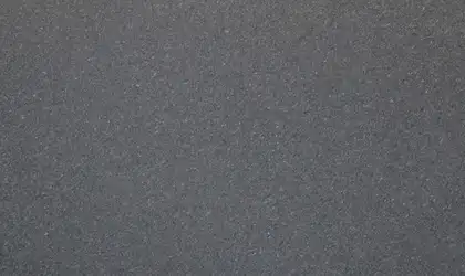 Closeup image of Black Pearl Polished (Leather) Grey Granite countertop slab